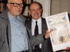 At the home of Andrei Sakharov. From the left: Andrei Sakharov displaying illuminated Jewish Art Calendar presented by Isi Leibler; Isi Leibler. Moscow, 1987. co RS